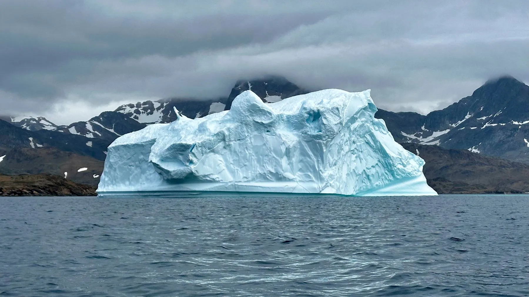 A Greenland Iceberg Rolls Over, on Camera